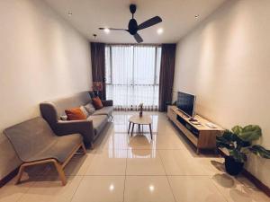 a living room with a couch and a tv at [PROMO]Connected train 2 Bedroom ABOVE MALL (22) in Kuala Lumpur