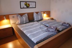 a bed with two blankets and pillows on it at Ferienwohnung Büren in Büren
