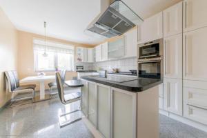 a kitchen with white cabinets and a counter top at Private House in Hannover