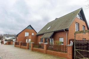 a row of brick houses with a fence at Private House in Hannover