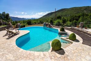 a swimming pool with a view of a mountain at Magnificent Villa Olka With Private Pool and Sauna in Žeževica