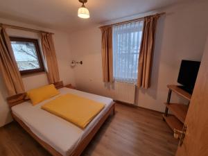Habitación pequeña con cama y ventana en Hotel Pension Geiger, en Bad Tölz