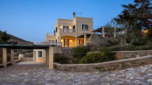 a house with a stone walkway in front of it at Pantaleon House in Ano Syros