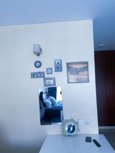 a room with a white wall with a blue light at Ruaka studio Airbnb in Ruaka