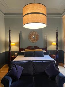 a bedroom with a large bed with a couch in it at Residenza dei Pucci in Florence