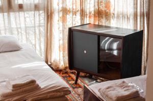 a bedroom with a bed and a tv in front of a window at The Forgotten Kingdom in Lchashen