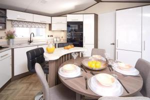 a kitchen and dining room with a table and chairs at Modern Luxurious Holiday Home with ocean views in Paignton