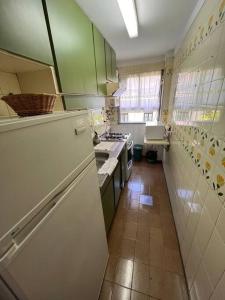 a kitchen with green cabinets and a white refrigerator at MDQ Centro - 4 personas - playa 4 cuadras - Todo cerca in Mar del Plata