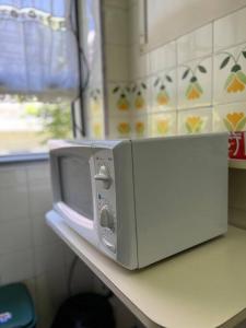 a microwave sitting on top of a counter at MDQ Centro - 4 personas - playa 4 cuadras - Todo cerca in Mar del Plata +6 photos