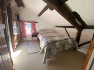 a bedroom with a bed in a attic at Tardoire cottage in Oradour-sur-Vayres
