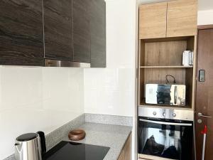 a kitchen with a stove and a microwave at Departamentos Concepcion Centro in Concepción +8 photos