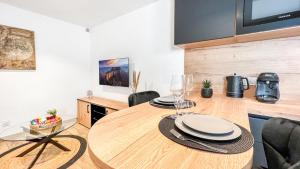 uma sala de jantar com uma mesa de madeira e cadeiras em HOMEY ETHAN - Free Parking - Terrasse privée - Wifi et Netflix - Jacuzzi em Monnetier-Mornex