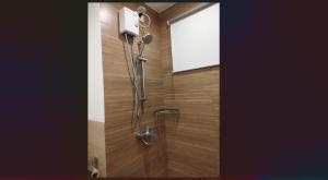 a shower in a bathroom with a glass door at Cozy Suite Studio type condo in Matina Enclaves in Davao City