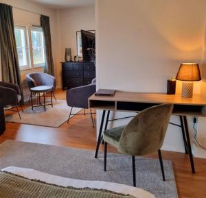 a living room with a desk and a chair at Hotell Monica in Hagfors