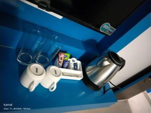a blue counter top with glasses and a sink at Mandrem Retreat Beach resort in Mandrem