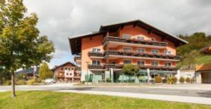 a large orange building in the middle of a street at Gasthof Sagwirt in Krispl