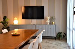 a dining room with a table and a flat screen tv at Chrisiola in Galleno