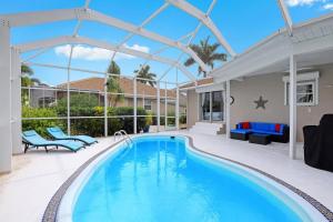a swimming pool with a patio and a house at 768 Sea Court in Marco Island