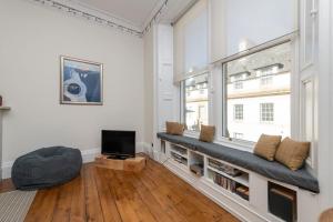 a living room with a bench and a window at Spacious 2 bedroom High Street apartment in North Berwick