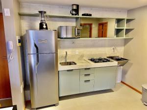 a kitchen with a stainless steel refrigerator and a sink at Edifício Top Unique ER Hospedagens in Maceió