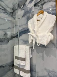 a bathroom with white towels on a glass wall at Centrico Tanger Idrissia 3 in Tangier