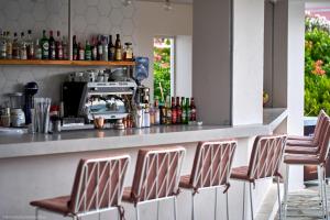 a bar with four chairs sitting at a counter at Seaside Studios in Kavos