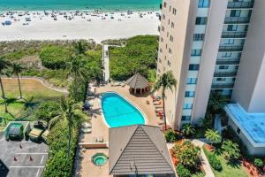an aerial view of a resort with a swimming pool and the beach at Charming beachfront condo with pool, spa and views in Marco Island