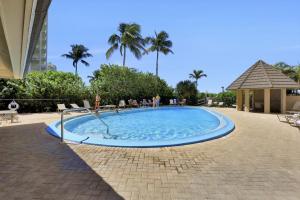 a swimming pool in a resort with palm trees at Seawinds 1505 in Marco Island