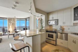 a kitchen with a counter and a table with chairs at Sandcastle I-1201 in Marco Island