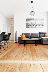 a living room with a couch and a table at Be in Berlin Apartments im Bergmannkiez in Berlin