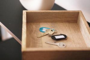 a wooden box with a pair of keys and a cell phone at Be in Berlin Apartments im Bergmannkiez in Berlin