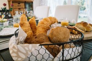 a basket of bread and croissants on a table at Bed & Breakfast Lake View in Steckborn