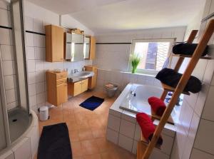 a bathroom with a tub and a sink and a shower at _Ferienhaus Leutesdorf Rheinzeit 614 schönes Haus direkt am Rhein in Leutesdorf +71 photos
