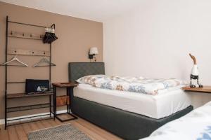 a bedroom with a bed and a table with a night stand at _Ferienhaus Leutesdorf Rheinzeit 614 schönes Haus direkt am Rhein in Leutesdorf