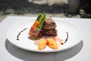 a plate of food with meat and vegetables on a table at SCARLET SAILS BUNGALOW in Koh Rong Island