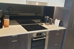 a kitchen with a stove and a counter top at Executively Inspired - The Hutt in Brisbane