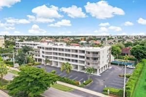 an aerial view of a white building with a parking lot at Beach Club 206 in Marco Island