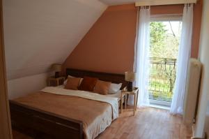 a bedroom with a bed and a large window at Pension Lübeck in Lübeck