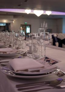 a table with wine glasses and plates and napkins at The Parkview Hotel in Newtown Mount Kennedy