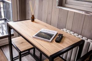 a table with a tablet and a remote control on it at Wansbeck Riverside Caravan Park in Ashington