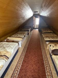 a row of bunk beds in a room with a red carpet at Chalupa Juli in Velké Karlovice