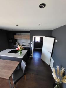 a kitchen with a white counter and a white refrigerator at Quartier4 in Sonthofen