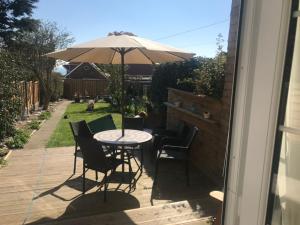 a table and chairs with an umbrella on a patio at Seaview Cottage in Bridlington