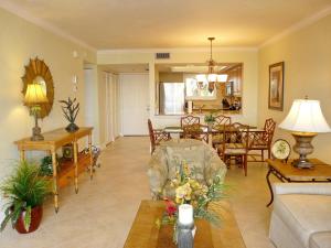 a living room with a couch and a table at Tranquil waterfront condo with pool and steps to beach in Marco Island