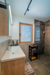 a bathroom with a sink and a shower at Apartment Hoflacher in Schwendau