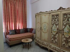 a living room with a couch and a large cabinet at Hotel Sanremo in Sanremo