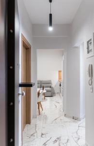 a hallway with a door and a living room at Suite Apartment Siatista in Siátista