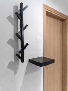 a black shelf on the wall next to a door at Suite Apartment Siatista in Siátista