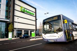 a bus is parked in front of a building at Holiday Inn London Heathrow - Bath Road, an IHG Hotel in Hillingdon