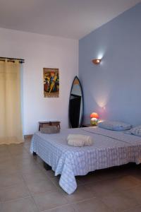 a bedroom with a bed with two towels on it at Sakaroule B&B in Santa Maria